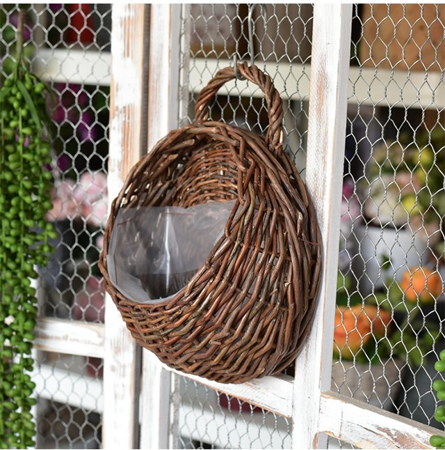 Hanging basket displayed on a garden fence