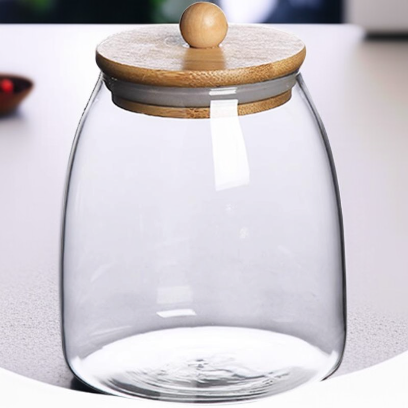 Recipiente para té de vidrio transparente con tapa de bambú y madera.