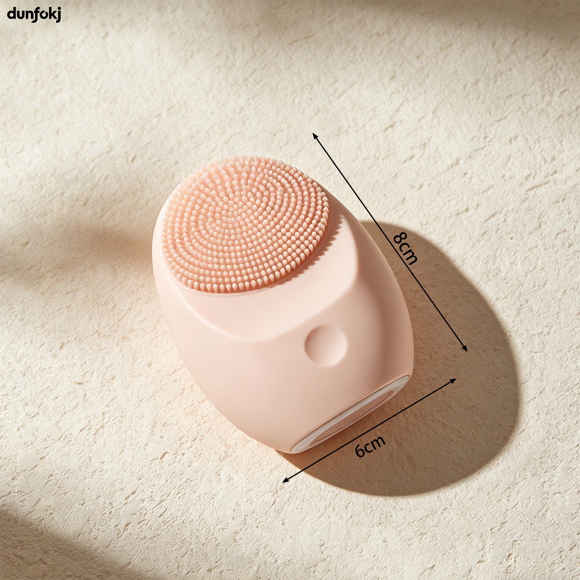Hand holding silicone face cleansing brush