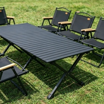 Portable camping table and chairs set up for an outdoor meal