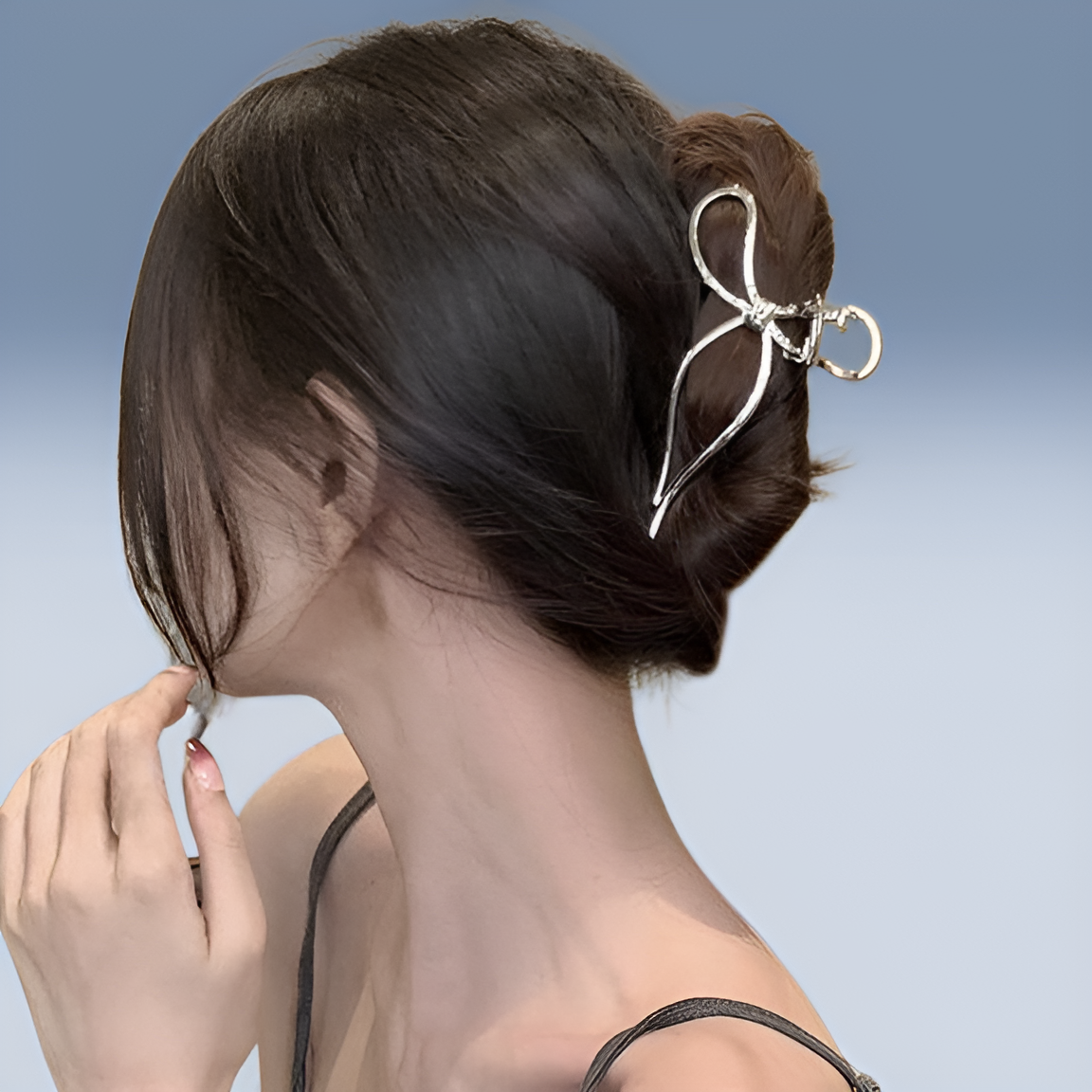 Stylish metal clip holding hair at the back