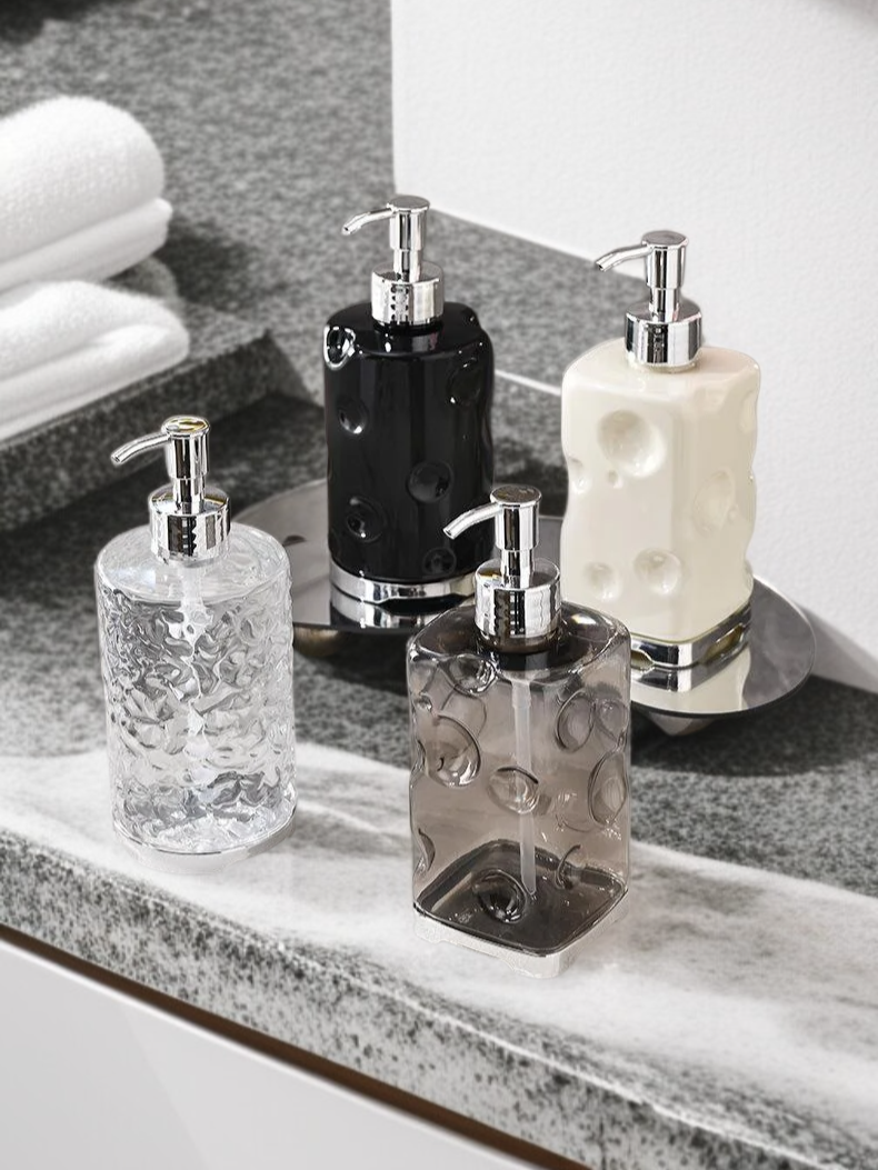 Stylish shower gel and soap dispensers in minimalist bathroom