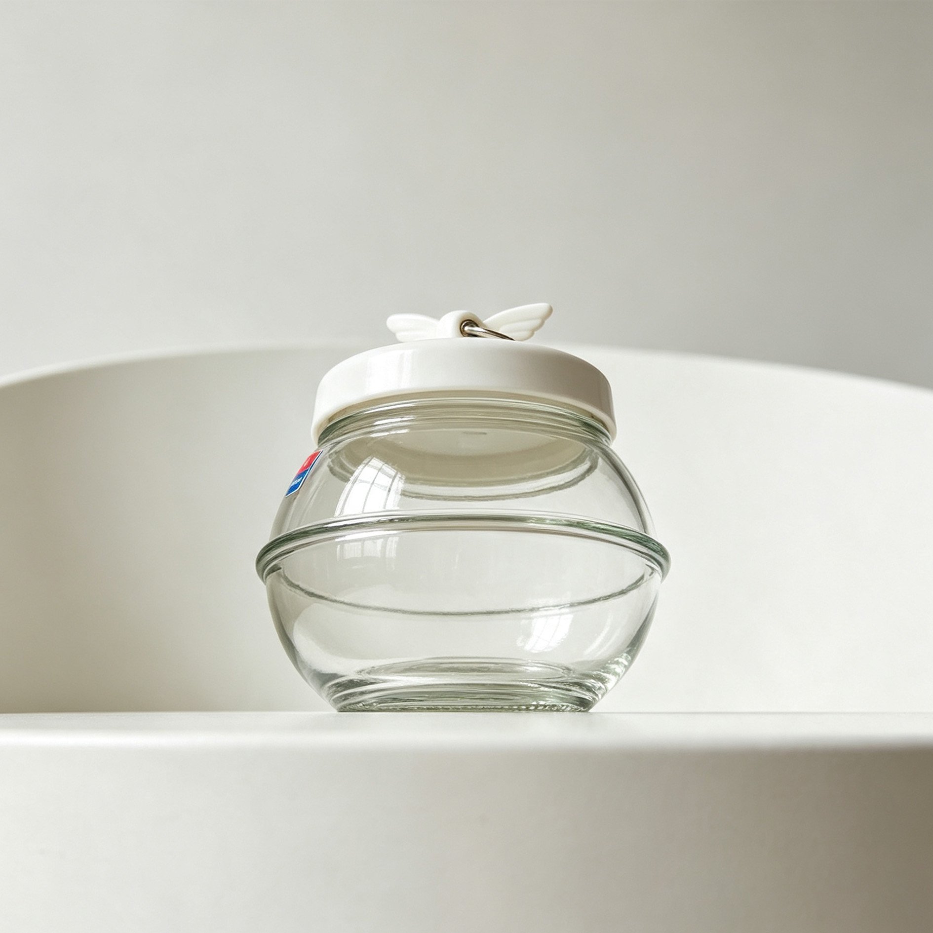 Elegant Decorative Glass Jar with Angel Wing Design
