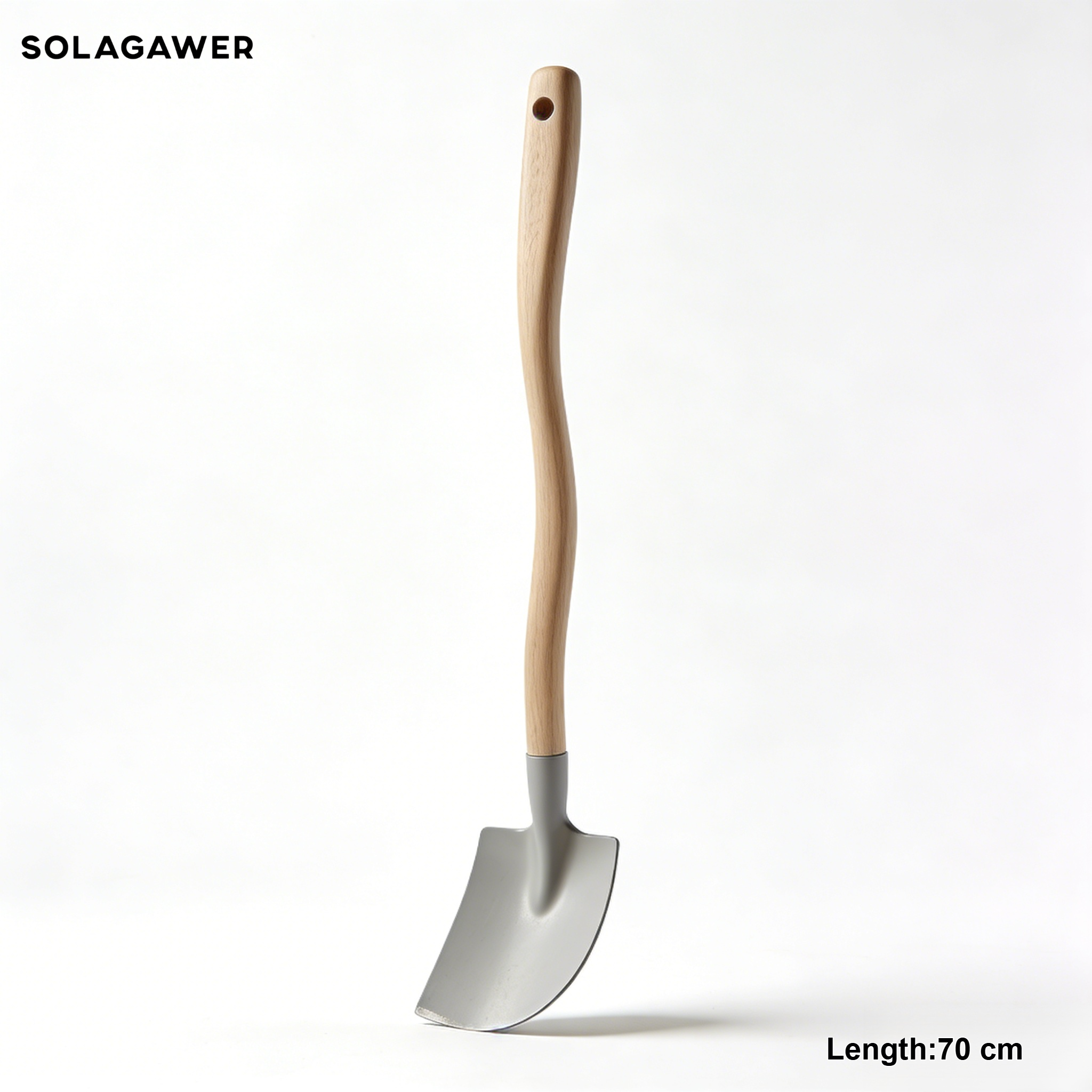 Hand holding a small gardening trowel in soil