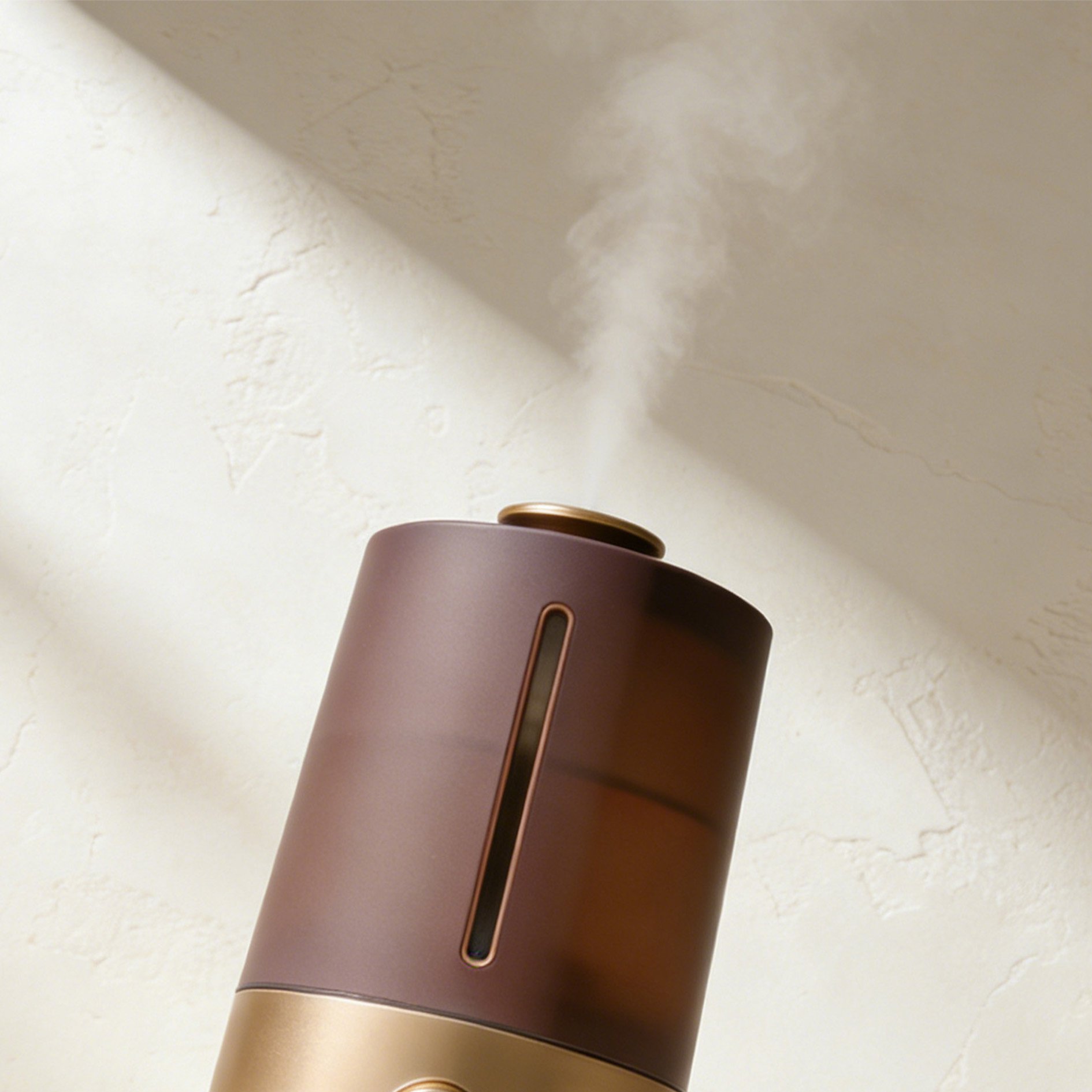 Portable humidifier with USB charging on wooden desk