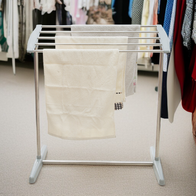 Freestanding stainless steel clothes drying rack in modern laundry room