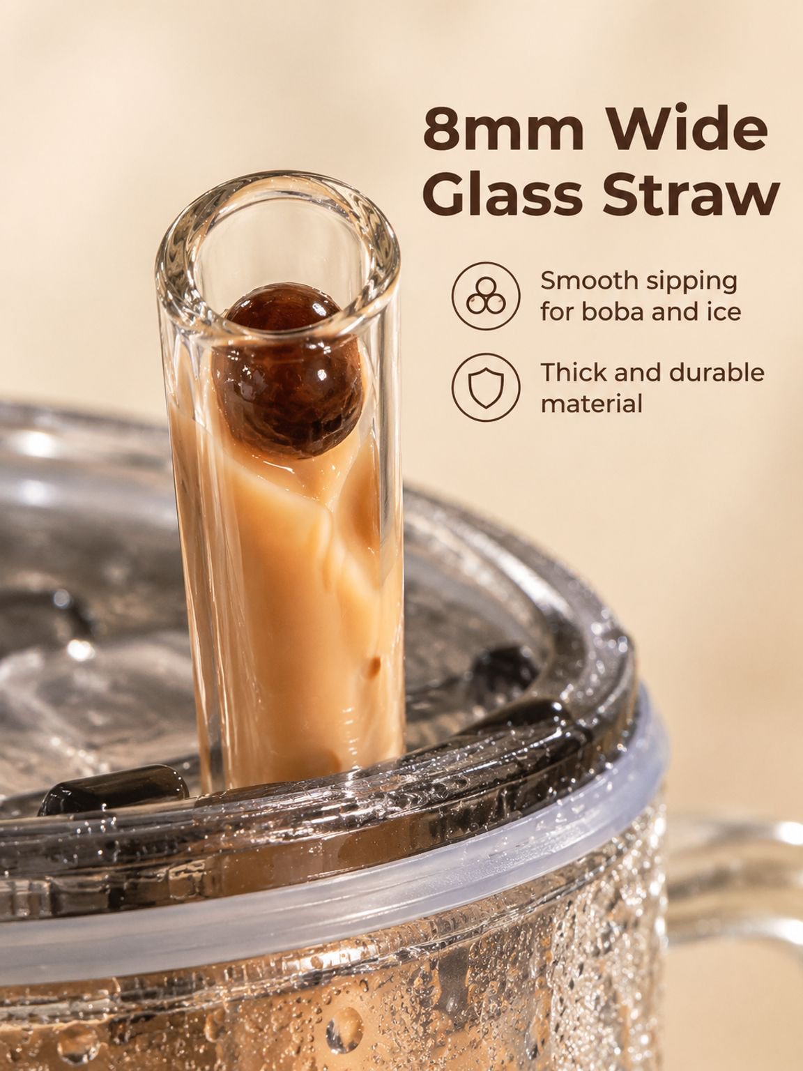 Large handled glass cup filled with iced coffee and a straw