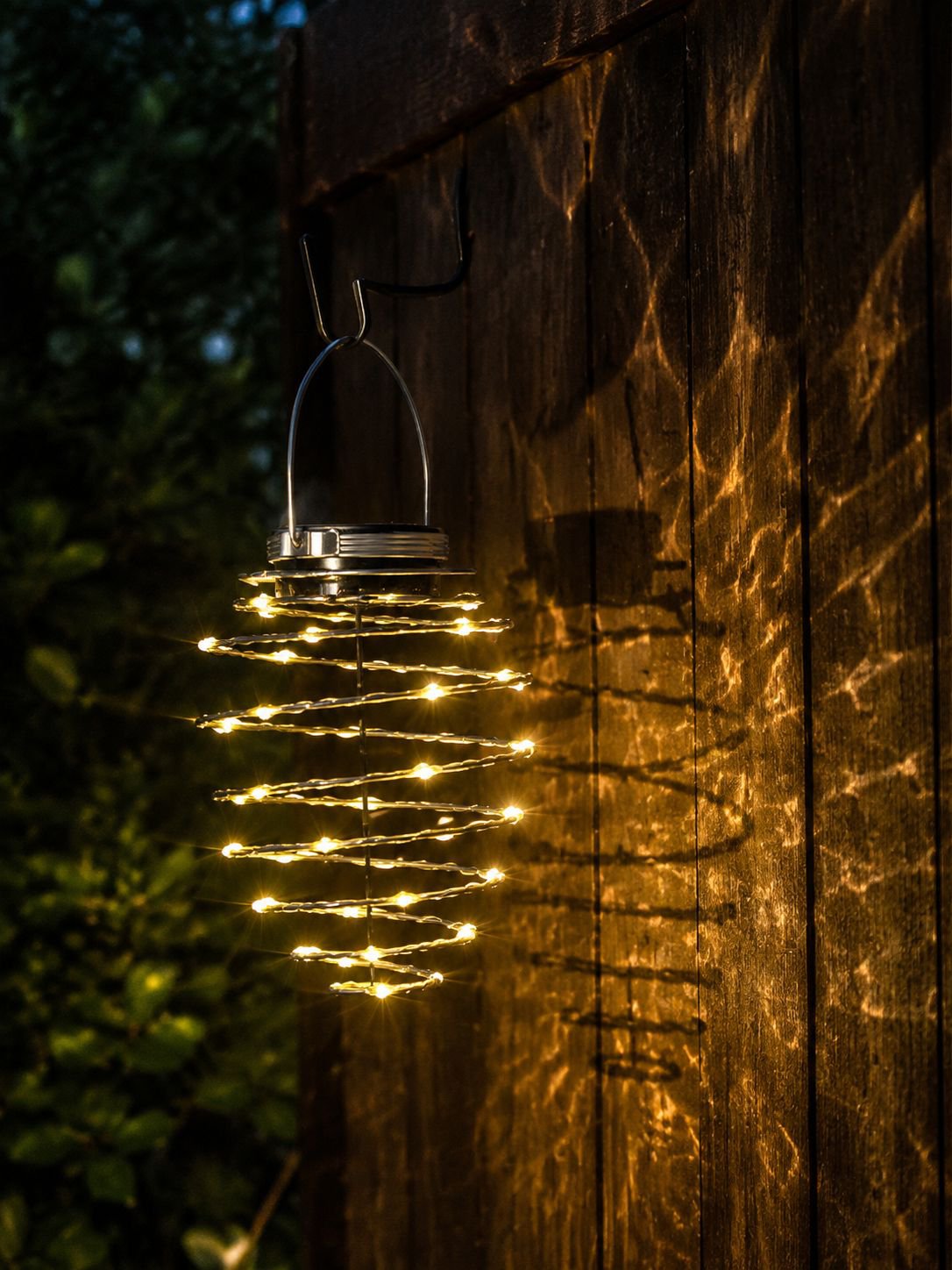 LED pineapple lantern illuminating outdoor patio at night