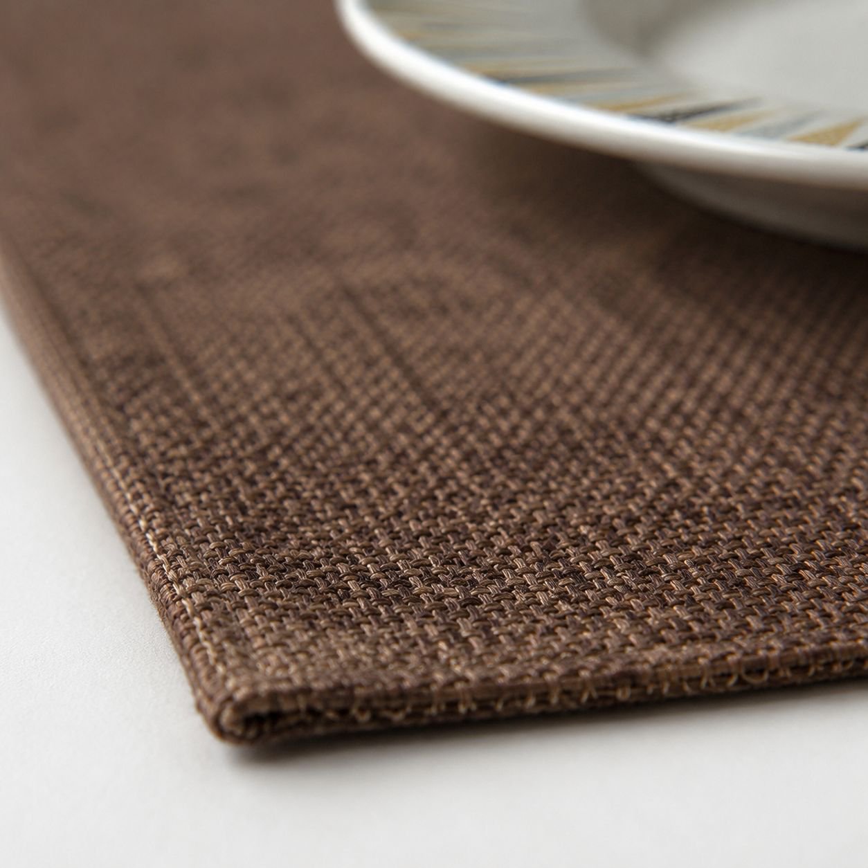 Washable linen placemat protecting wooden table