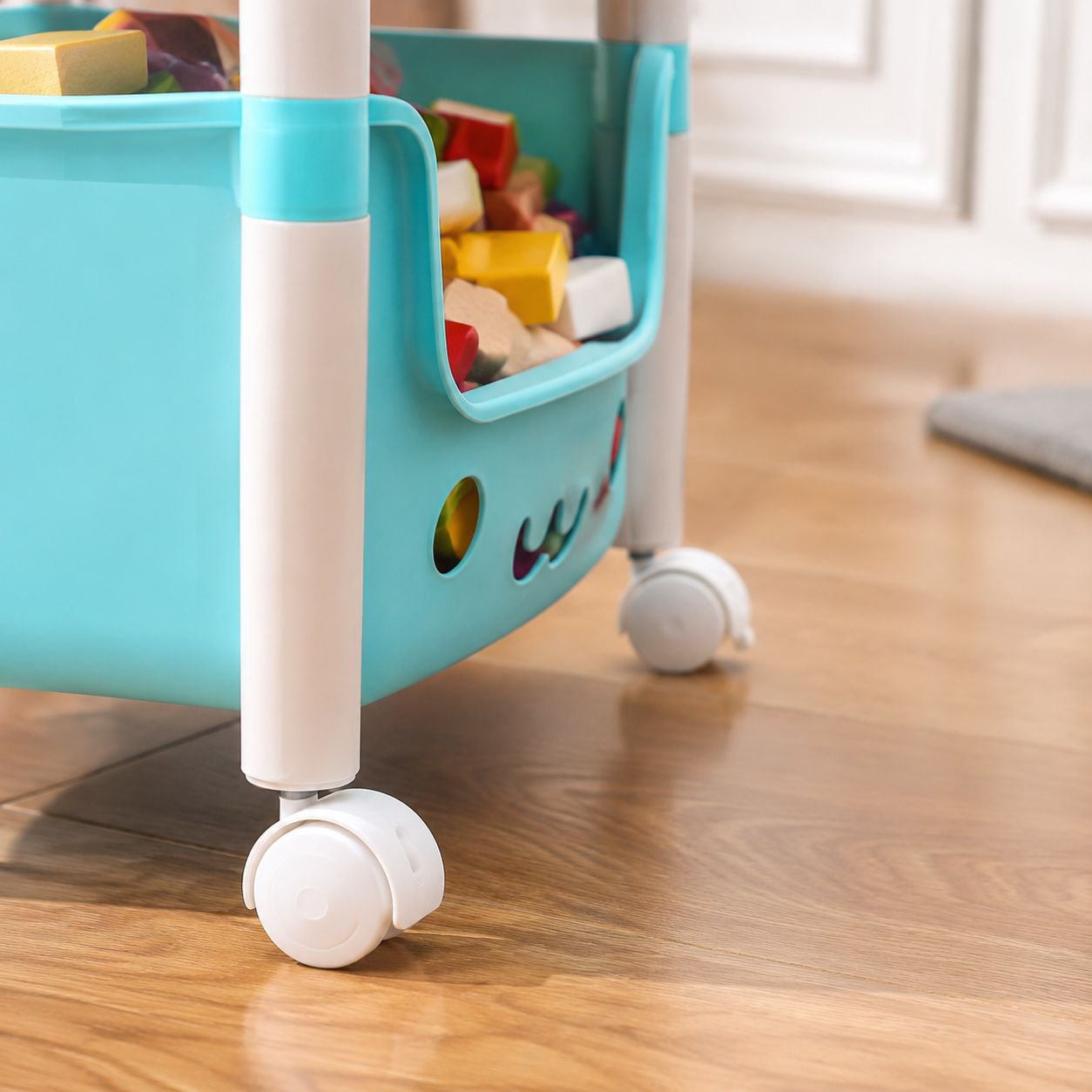 Rolling toy organizer cart in nursery setting