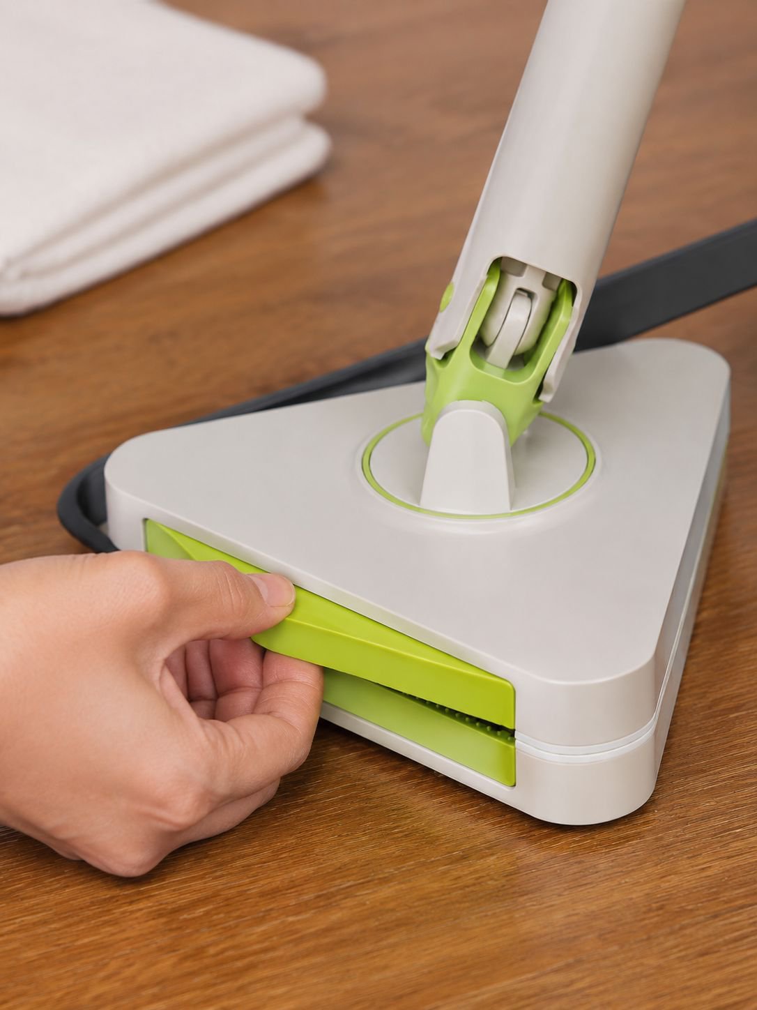 Ergonomic grip cleaner in hand wiping kitchen surface