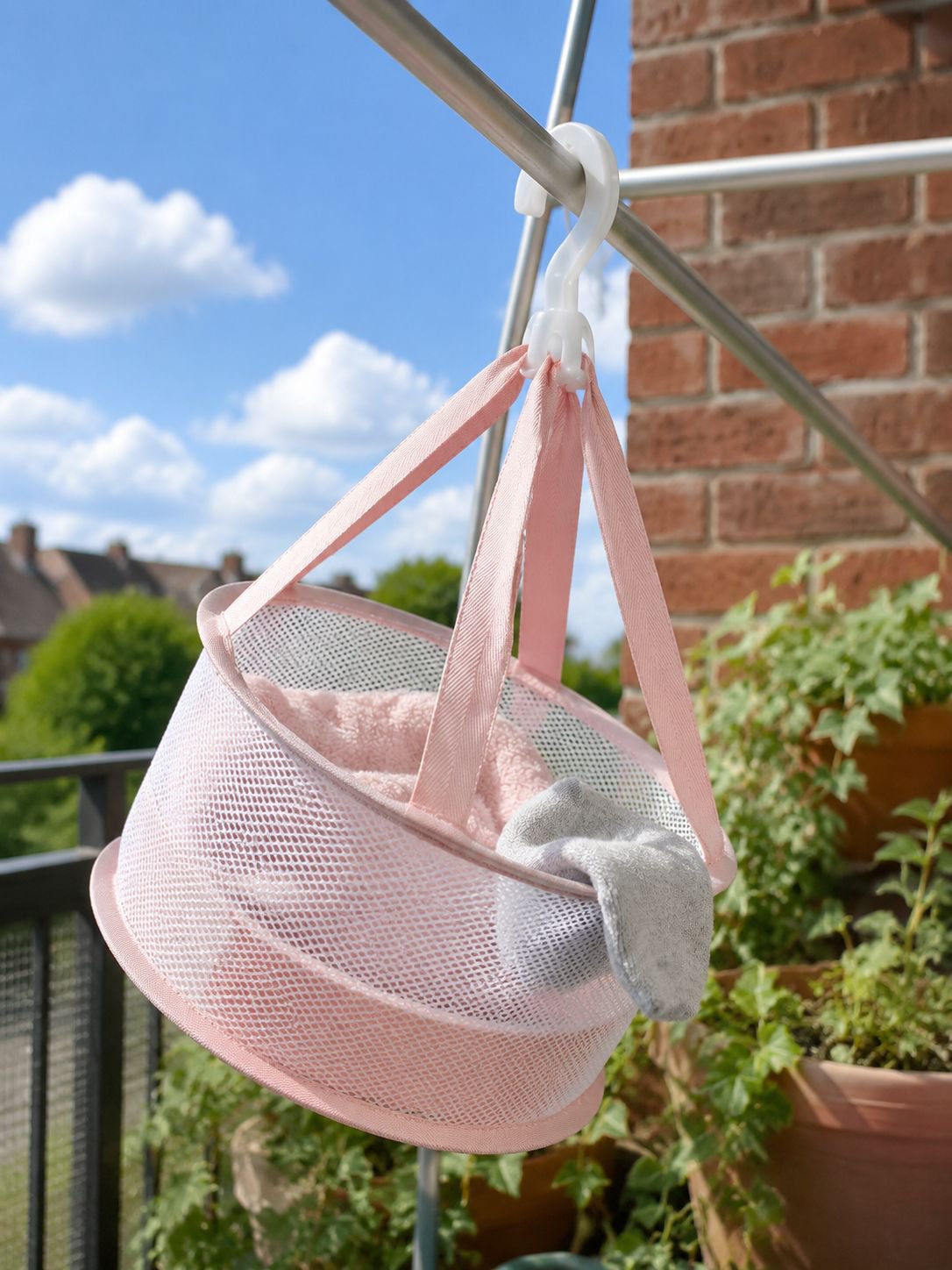 Hanging mesh laundry basket on balcony