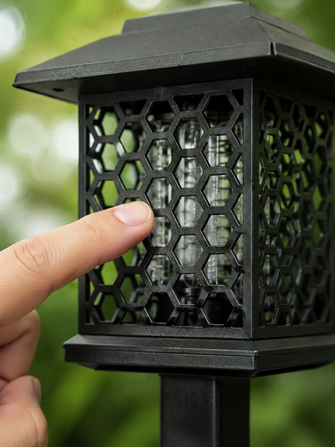 Solar mosquito trap light installed on garden lawn
